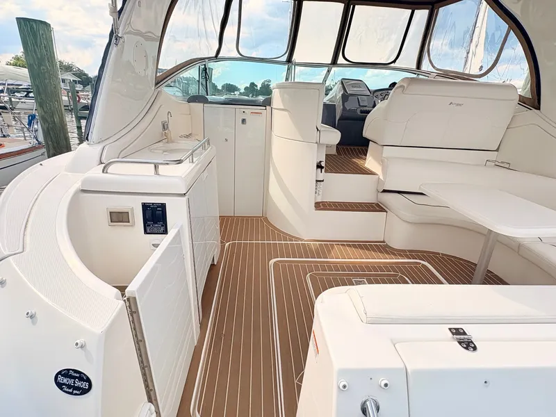 Slide: The Image of The image shows the cockpit of a 2007 Cruisers 37O Express with sleek seating and wood flooring. - 9
