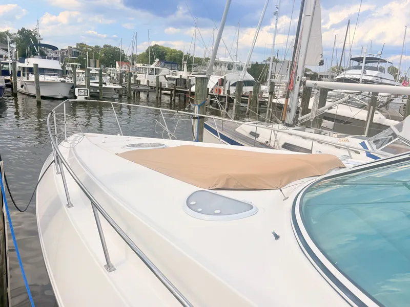 Slide: The Image of A 2007 Cruisers 37O Express is docked in a busy marina. - 5