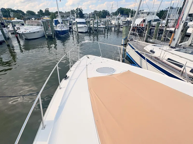 Slide: The Image of The 2007 Cruisers 37O Express is docked in a busy marina, surrounded by other boats. - 6