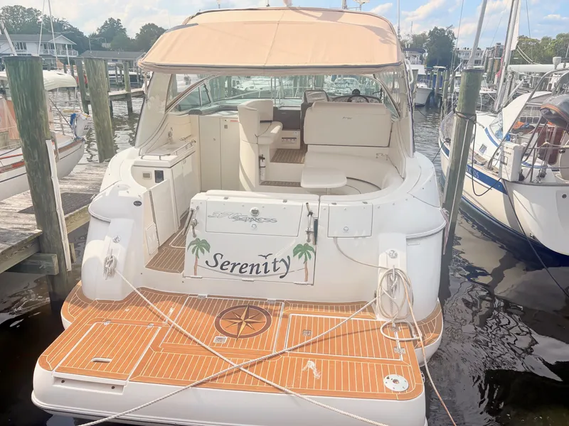 Slide: The Image of A 2007 Cruisers 37O Express named "Serenity" docked at a marina. - 1