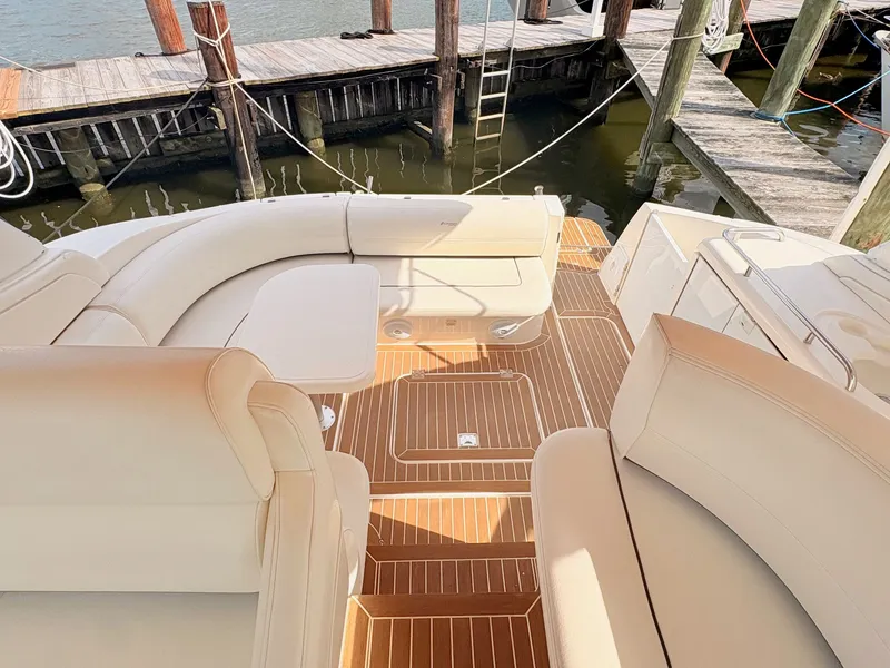 Slide: The Image of The image shows the cockpit of a 2007 Cruisers 37O Express with elegant seating and wood flooring. - 18