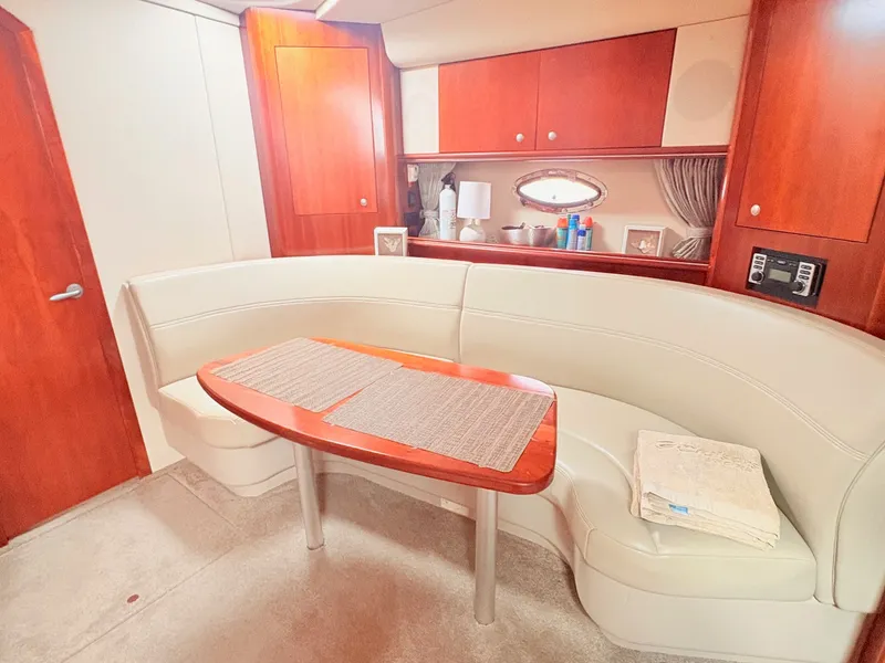 Slide: The Image of Interior of a 2007 Cruisers 37O Express with an elegant seating area and wooden table. - 23