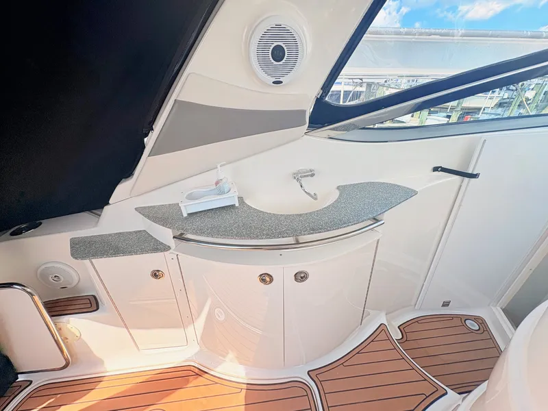 Slide: The Image of The 2007 Cruisers 37O Express features a sleek outdoor kitchenette with a sink and speaker. - 11