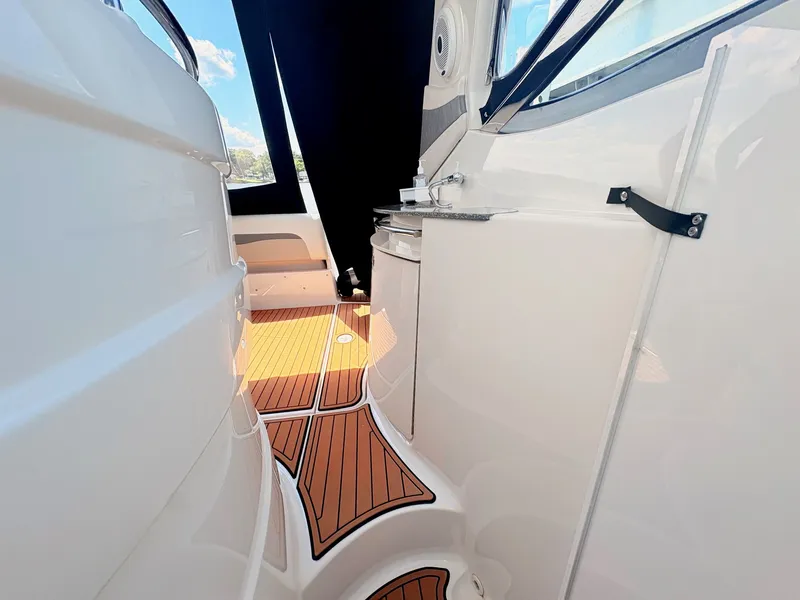 Slide: The Image of The 2007 Cruisers 37O Express features a sleek deck with teak-style flooring and modern details. - 14