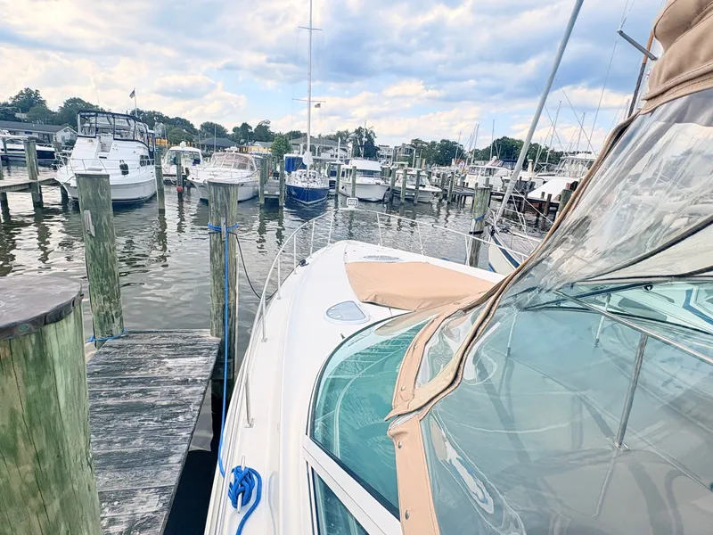 Slide: The Image of A 2007 Cruisers 37O Express is docked in a busy marina. - 4
