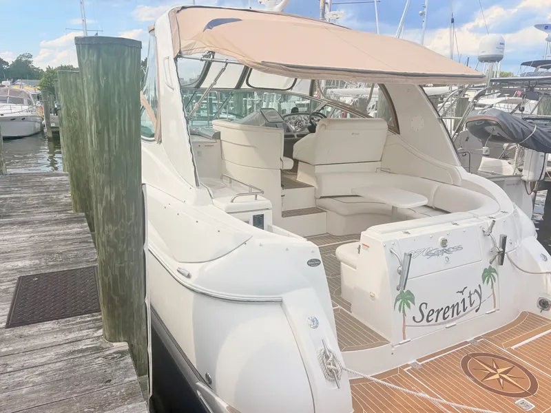 Slide: The Image of A luxurious white yacht docked, featuring beige sunshade and elegant seating. - 2