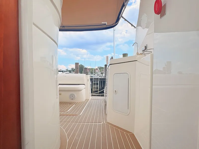 Slide: The Image of The image shows the deck of a 2007 Cruisers 37O Express with wood flooring and a harbor view. - 33