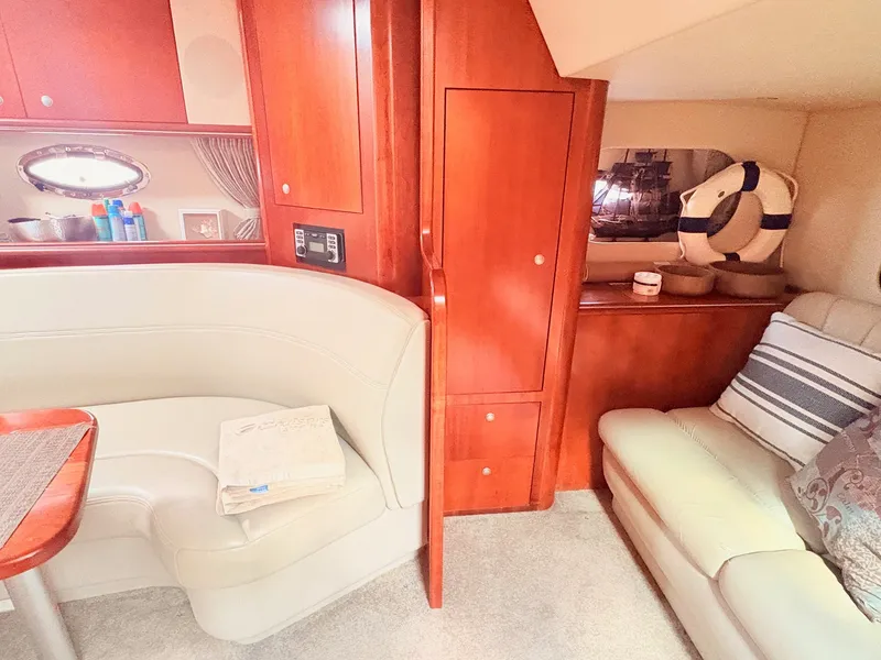 Slide: The Image of The interior cabin of a 2007 Cruisers 37O Express with cream upholstery and wooden furnishings. - 22