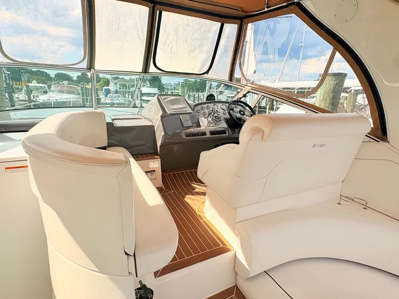 Slide: The Image of The cockpit of a 2007 Cruisers 37O Express with beige leather seats and a modern helm station. - 13