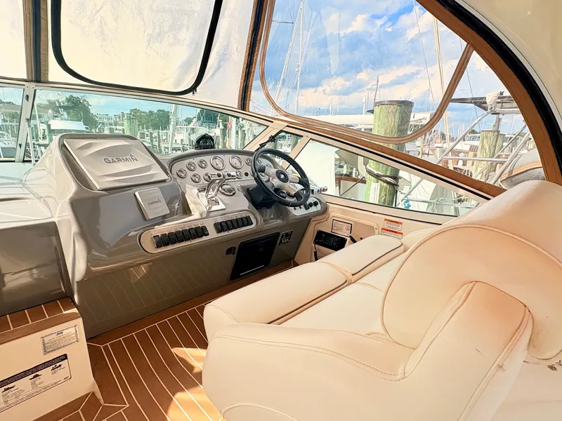 Slide: The Image of The cockpit of a 2007 Cruisers 37O Express with beige leather seating and modern instruments. - 16