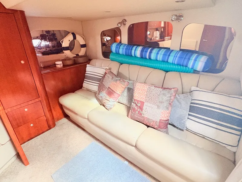 Slide: The Image of The cabin of a 2007 Cruisers 37O Express features a cozy sofa with decorative pillows. - 30