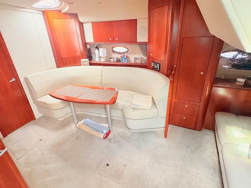 Slide: The Image of Interior of a 2007 Cruisers 37O Express with cream upholstery and wooden cabinetry. - 20
