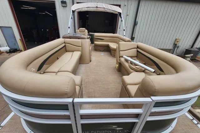 Slide: The Image of 2018 Bennington SSX21 pontoon boat with beige seating and spacious deck layout. - 5