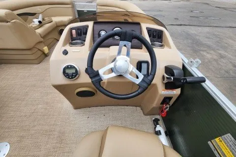 Slide: The Image of Steering console of a 2018 Bennington SSX21 boat with beige interior and controls. - 6