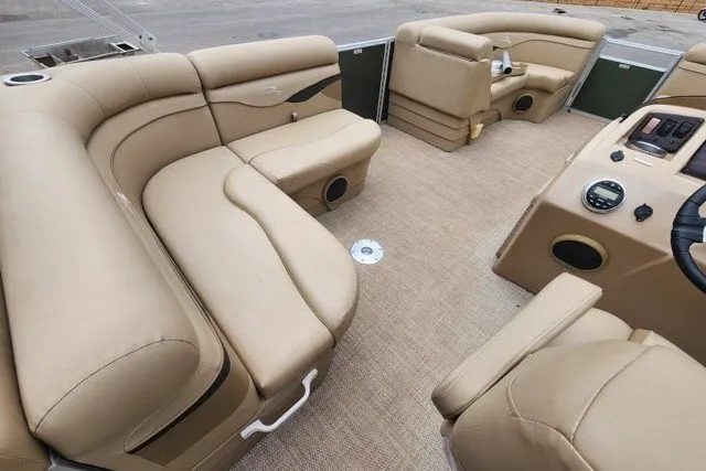 Slide: The Image of 2018 Bennington SSX21 boat interior with beige seating and modern dashboard. - 7