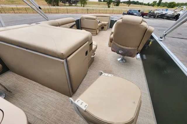Slide: The Image of 2018 Bennington SSX21 pontoon boat interior with beige seating and carpeted flooring. - 8