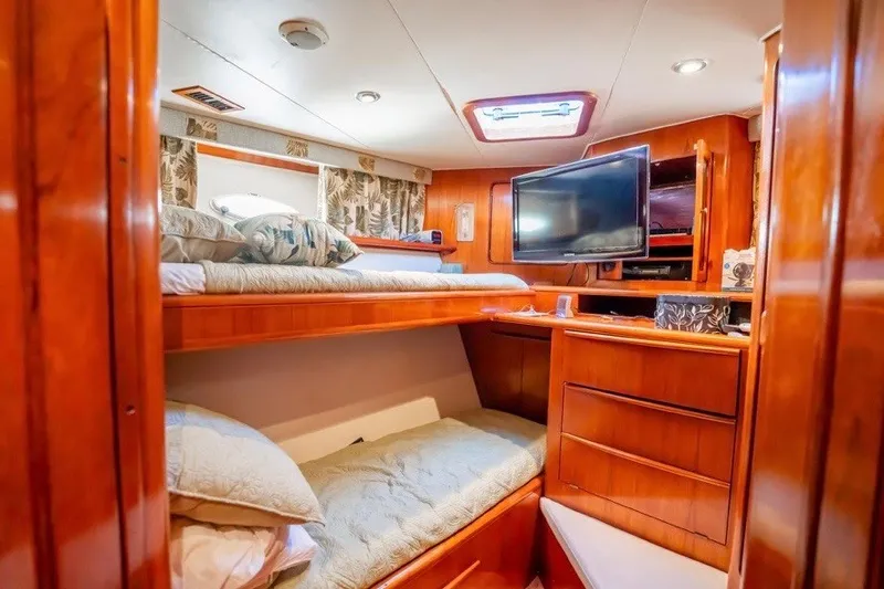 Slide: The Image of Interior of 1989 Viking 63 Motor Yacht with cozy bunk beds and wooden cabinetry. - 14