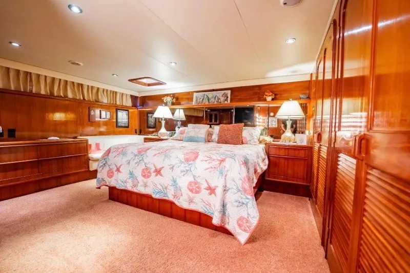 Slide: The Image of Luxurious bedroom interior of 1989 Viking 63 Motor Yacht with elegant wood finishes. - 11