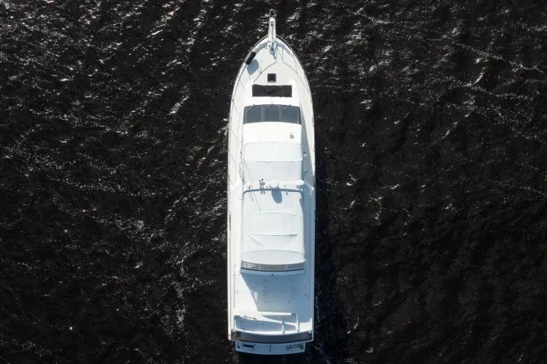 Slide: The Image of Aerial view of 1989 Viking 63 Motor Yacht on dark water. - 7