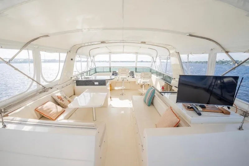 Slide: The Image of Spacious interior of 1989 Viking 63 Motor Yacht with seating and TV. - 30