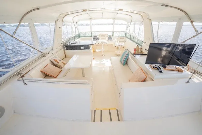 Slide: The Image of Luxurious interior of a 1989 Viking 63 Motor Yacht with seating and TV. - 28