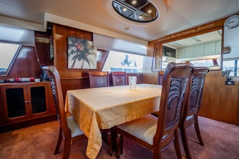 Slide: The Image of Luxurious dining area inside a 1989 Viking 63 Motor Yacht with elegant wooden furnishings. - 20