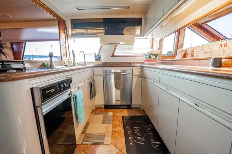 Slide: The Image of Modern kitchen interior on 1989 Viking 63 Motor Yacht, featuring stainless steel appliances. - 19