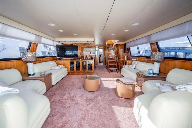 Slide: The Image of Luxurious interior of 1989 Viking 63 Motor Yacht with plush seating and elegant decor. - 16