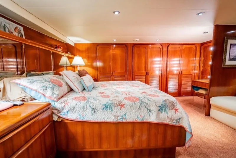 Slide: The Image of Luxurious bedroom in 1989 Viking 63 Motor Yacht with elegant wood paneling and cozy bedding. - 10