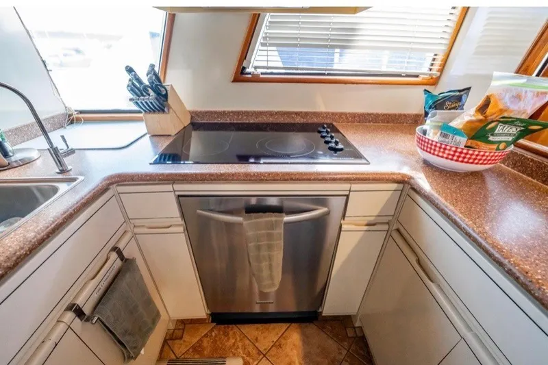 Slide: The Image of Kitchen area of a 1989 Viking 63 Motor Yacht with modern appliances. - 18