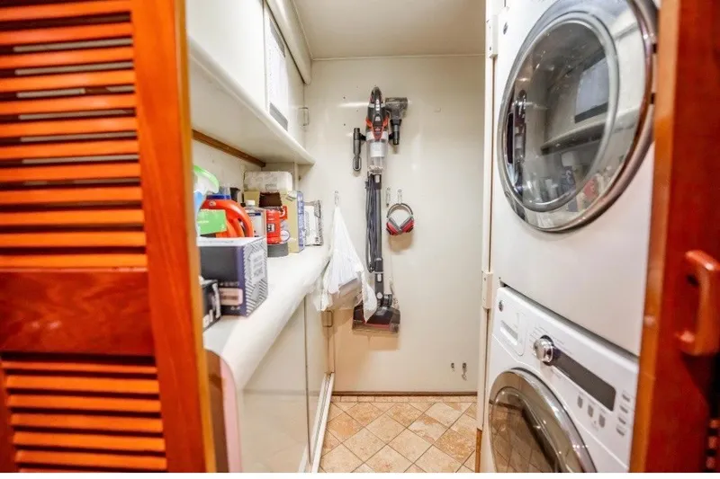 Slide: The Image of Laundry room in 1989 Viking 63 Motor Yacht with stacked washer and dryer. - 24