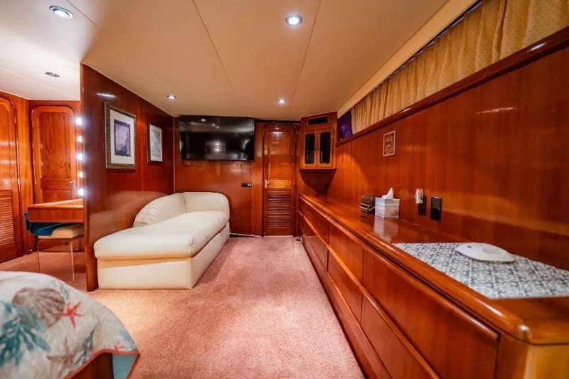 Slide: The Image of Luxurious interior of a 1989 Viking 63 Motor Yacht with wood paneling and plush seating. - 12