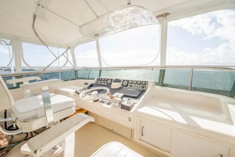 Slide: The Image of Helm of 1989 Viking 63 Motor Yacht with ocean view and navigational controls. - 27