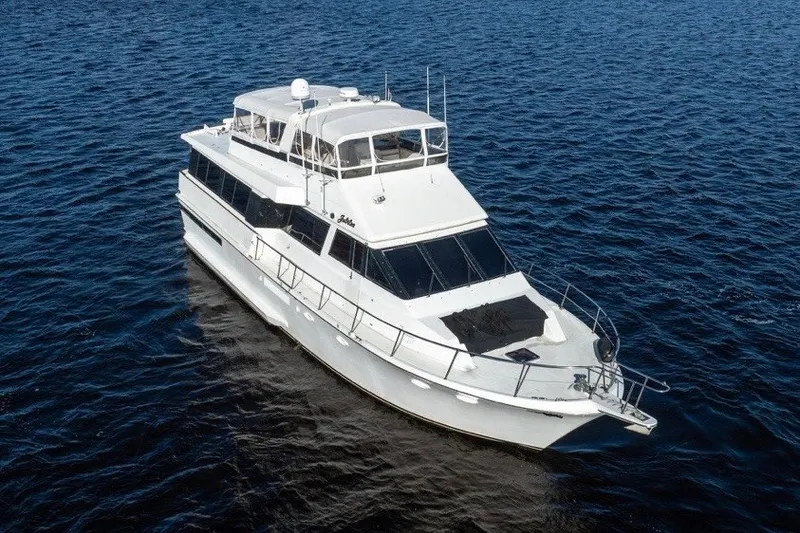 Slide: The Image of 1989 Viking 63 Motor Yacht cruising on open water, aerial view. - 6