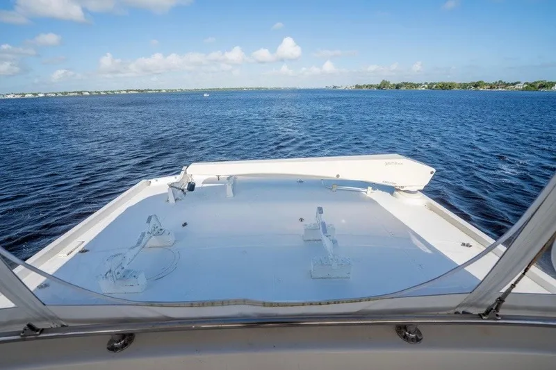 Slide: The Image of 1989 Viking 63 Motor Yacht deck view on open water under blue sky. - 31