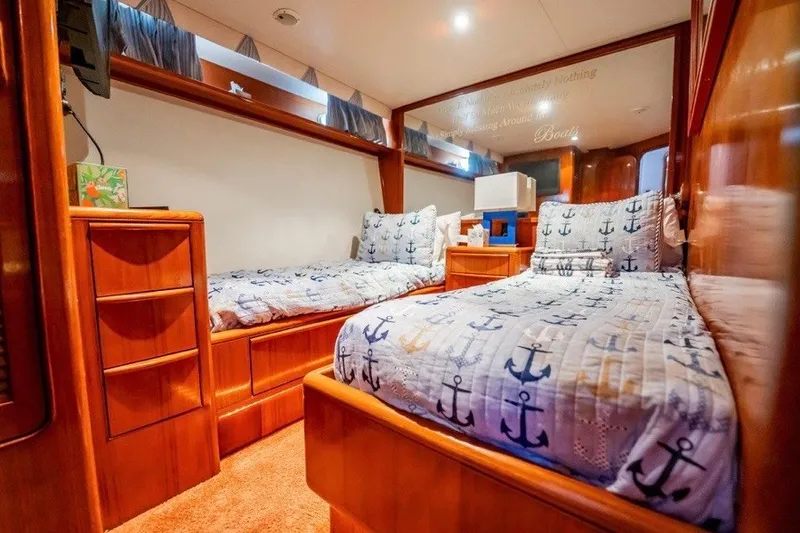 Slide: The Image of Interior of 1989 Viking 63 Motor Yacht with twin beds and nautical decor. - 13