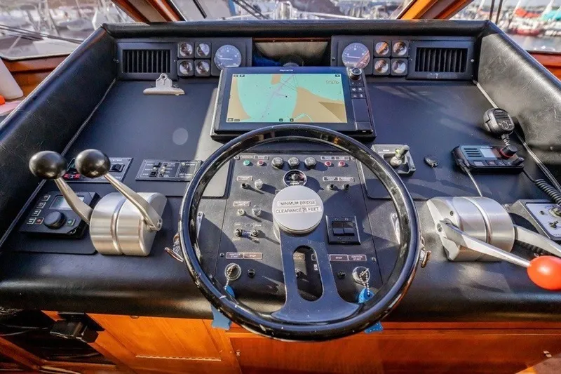 Slide: The Image of Cockpit of 1989 Viking 63 Motor Yacht with navigation controls and steering wheel. - 21
