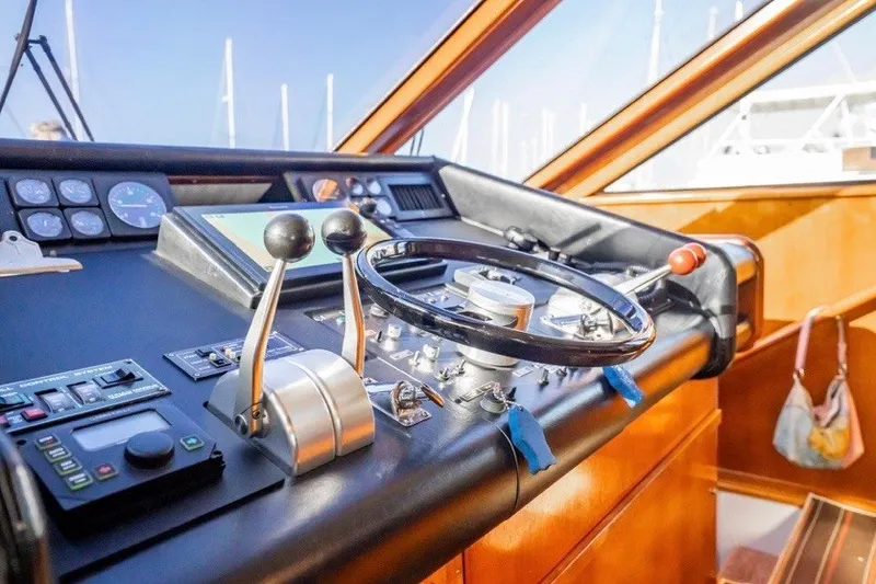 Slide: The Image of Helm of 1989 Viking 63 Motor Yacht with steering wheel and control panel. - 26