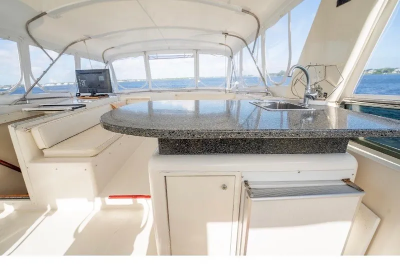 Slide: The Image of 1989 Viking 63 Motor Yacht interior with granite countertop and ocean view. - 29