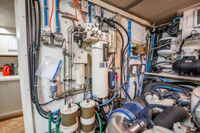 Slide: The Image of Engine room of 1989 Viking 63 Motor Yacht with complex machinery and piping. - 33