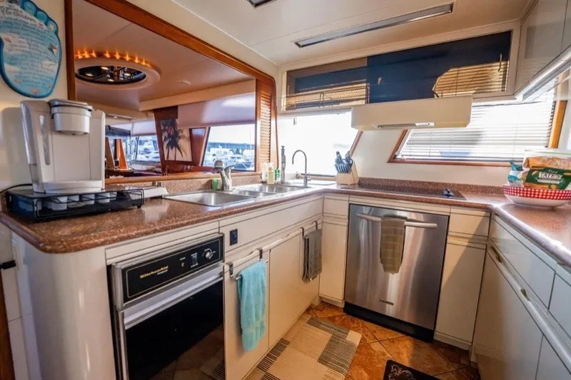 Slide: The Image of Luxurious kitchen interior of a 1989 Viking 63 Motor Yacht with modern appliances. - 23