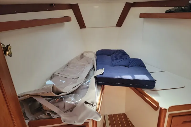 Slide: The Image of Interior cabin of a 2002 Tartan 3700 sailboat with blue cushion and storage. - 22