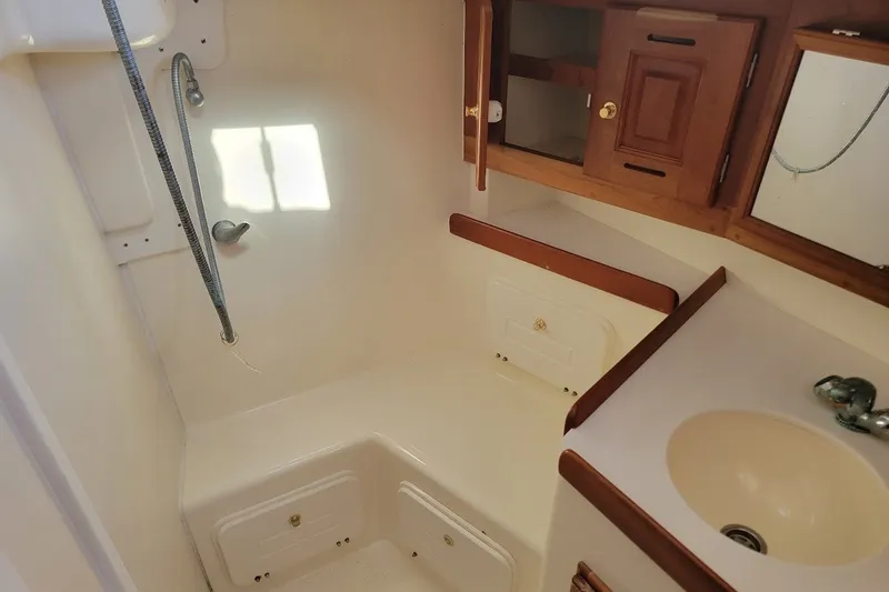 Slide: The Image of 2002 Tartan 3700 yacht bathroom with wooden cabinets and compact sink. - 17