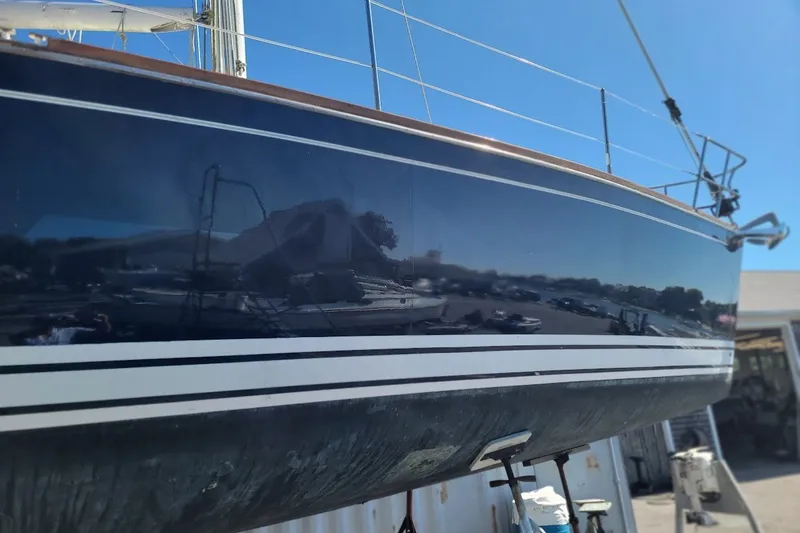 Slide: The Image of 2002 Tartan 3700 sailboat hull with sleek design and reflective finish. - 25