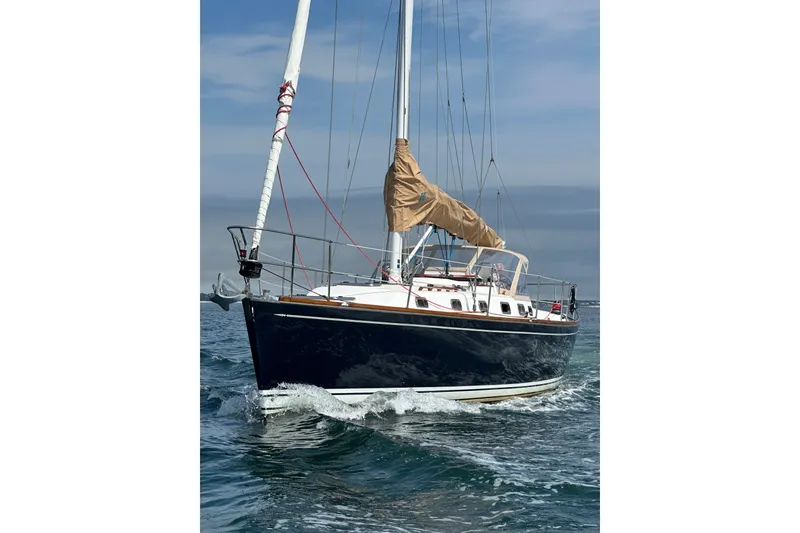 Slide: The Image of Sailing yacht Tartan 3700, 2002 model, cruising on open water under clear skies. - 37