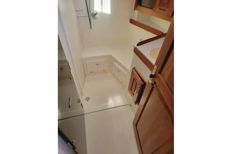 Slide: The Image of Interior of a 2002 Tartan 3700 sailboat bathroom with wooden cabinets. - 19