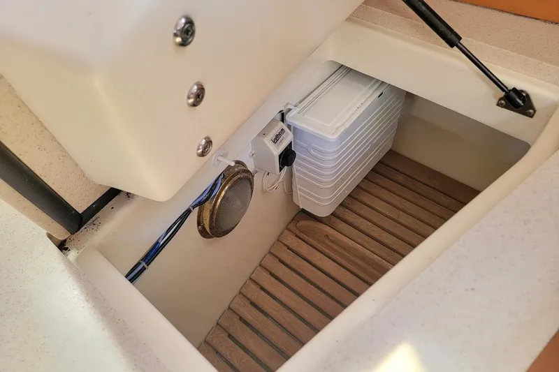 Slide: The Image of Storage compartment in a 2002 Tartan 3700 boat with wooden flooring and equipment. - 8