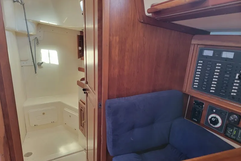 Slide: The Image of Interior of 2002 Tartan 3700 yacht showing shower and control panel area. - 16
