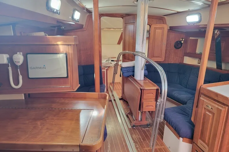 Slide: The Image of Interior of a 2002 Tartan 3700 sailboat with wood finish and Garmin navigation system. - 13