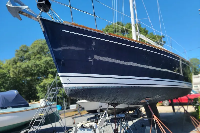 Slide: The Image of Sailboat Tartan 3700 from 2002 on dry dock, blue hull, sunny day. - 0